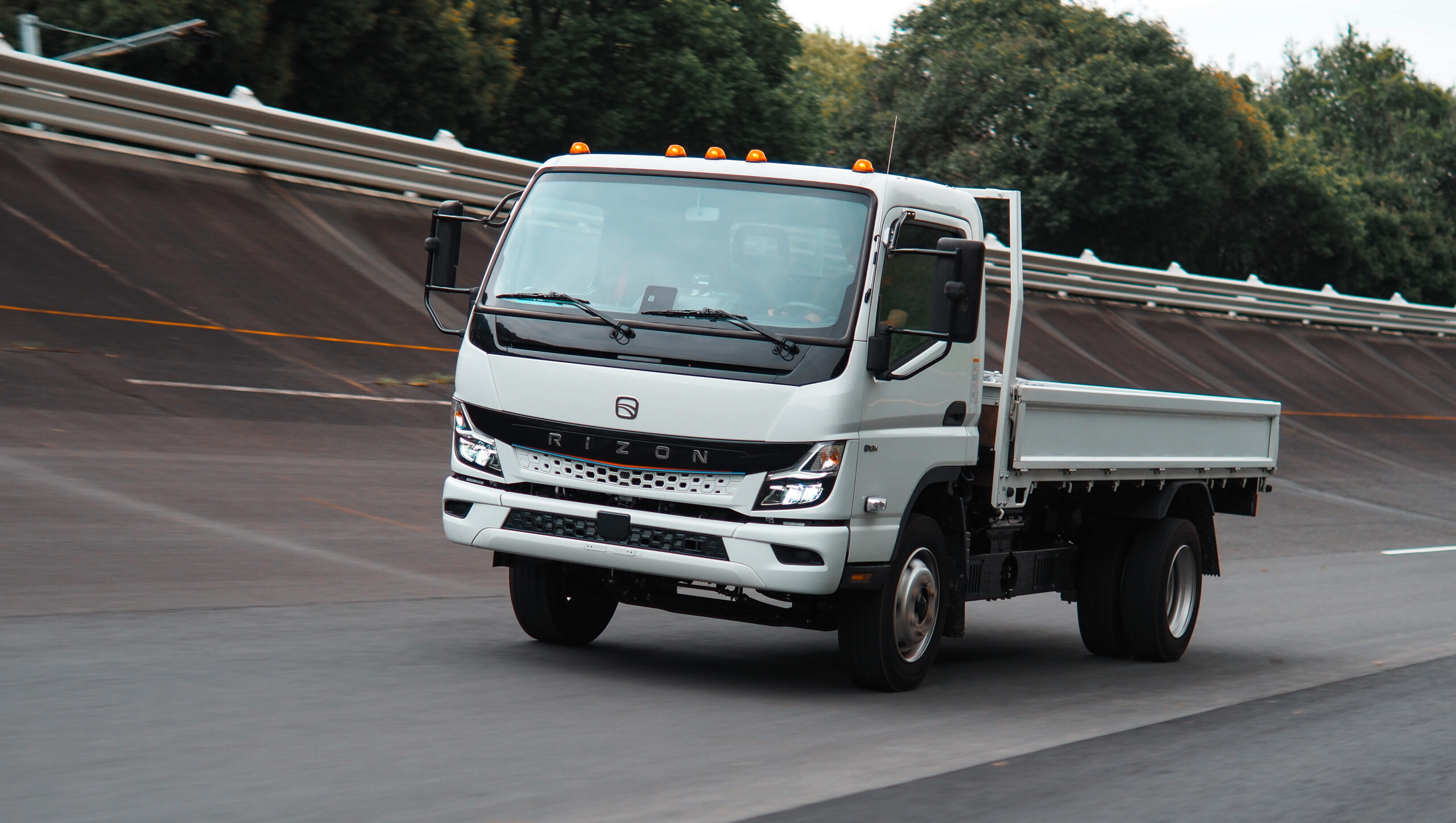 Mullen THREE Truck with icons representing features